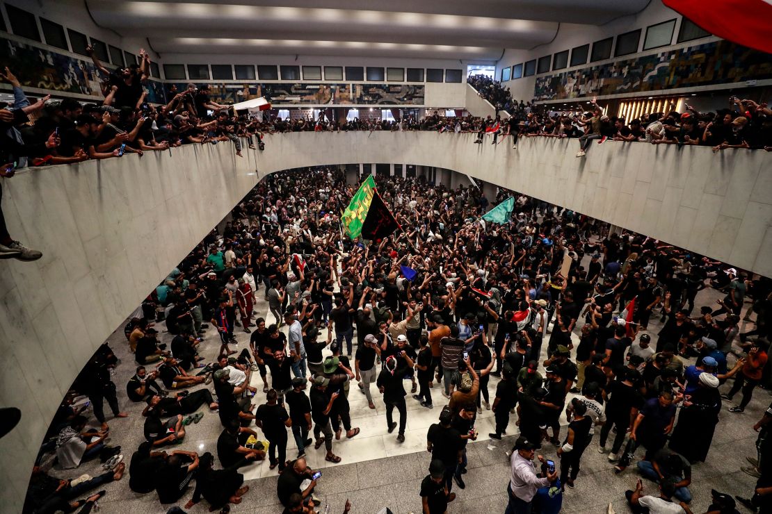 Protesters cheer after entering Iraq's parliament on Saturday.