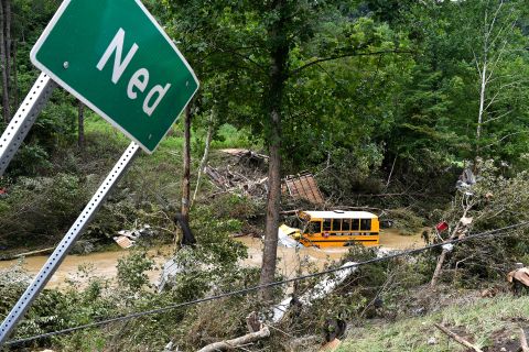 A Perry County school bus lies destroyed after being caught up in floodwaters in Ned, Kentucky, on Friday.