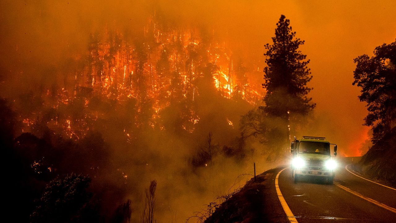 A fire truck drives along California Highway 96 as the McKinney Fire burns in Klamath National Forest, California on July 30, 2022.