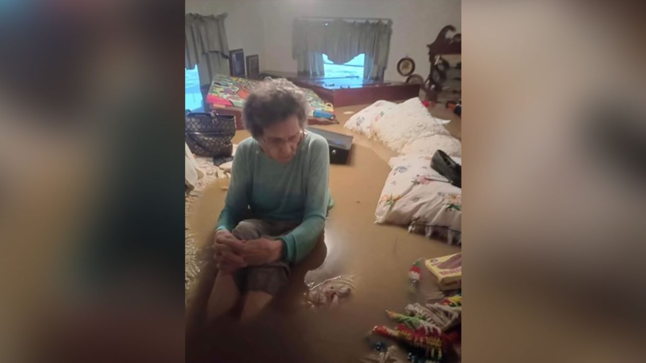 Mae Amburgey sits in floodwaters inside her home in Whitesburg, Kentucky, on July 28. 