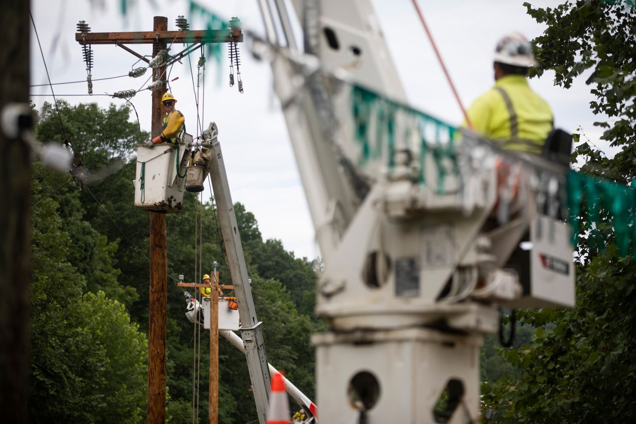 Crew members work to restore power lines near Hindman on Saturday. 