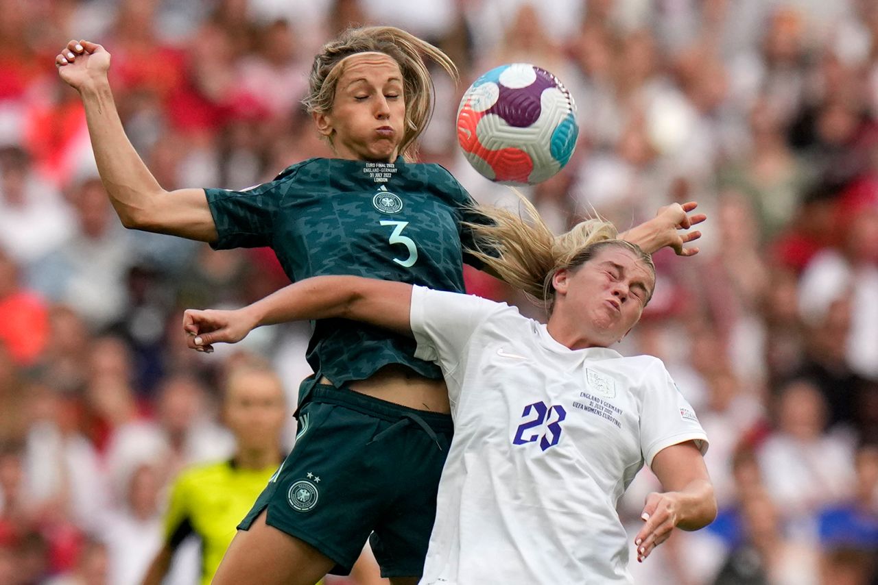 England's Alessia Russo, right, vies for the ball with Germany's Kathrin-Julia Hendrich.