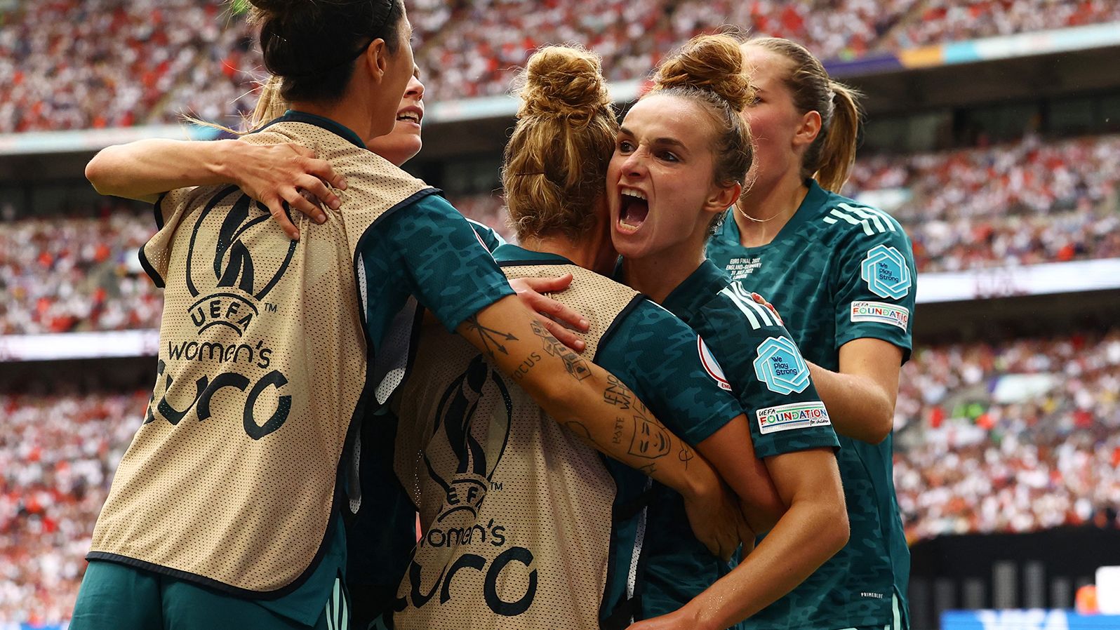 Germany's Lina Magull celebrates scoring the team's first goal with teammates.