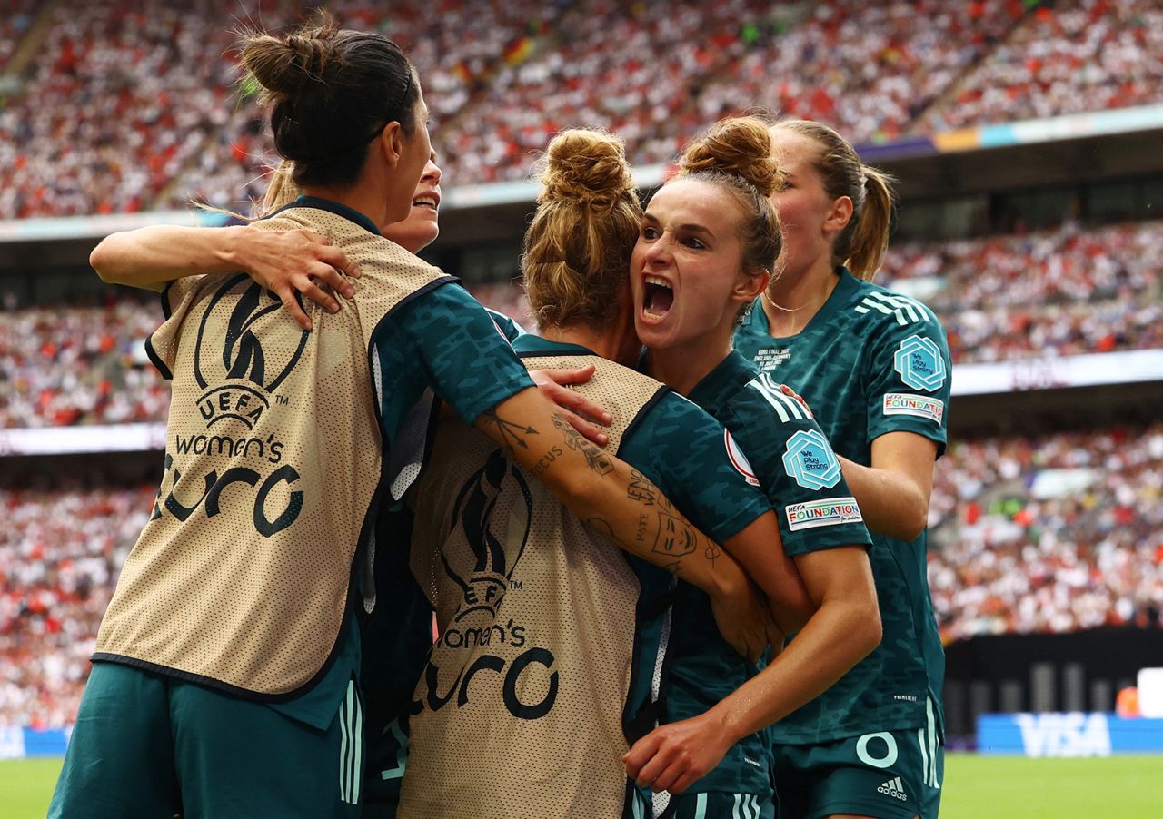 Germany's Lina Magull celebrates scoring the team's first goal with teammates.