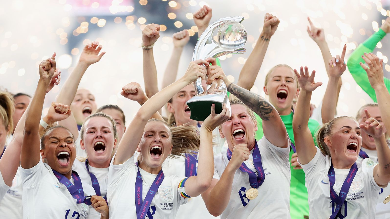 England's Leah Williamson and Millie Bright lift the UEFA Women's EURO 2022 Trophy after their team's victory.