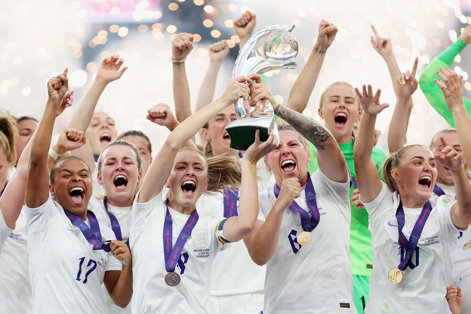 England's Leah Williamson and Millie Bright lift the UEFA Women's EURO 2022 Trophy after their team's victory.