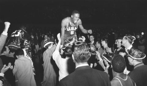 Russell is lifted up by fans after the USF Dons won the NCAA title in Kansas City, Missouri, in 1955. <br />
