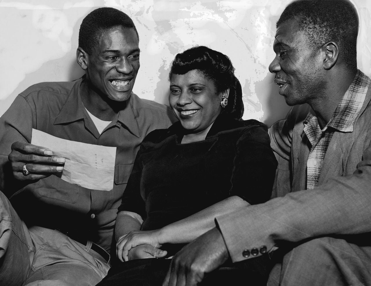 From left, Russell shows his parents Katie and Charles Russell a telegram informing him he made the first string All-American team in Oakland, California, in February 1955.