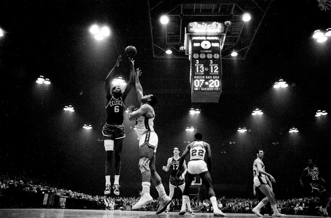 Russell, left, shoots over Cincinnati's Wayne Embry during a playoff game in Cincinnati, Ohio, in 1966. 