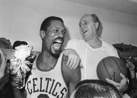 Russell celebrates with Auerbach in the locker room after defeating Los Angeles to win the 1966 NBA title. It was the team's eighth consecutive championship and Russell's ninth overall. He would go on to win two more in 1968 and 1969.