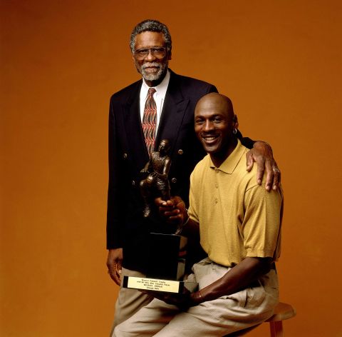 Russell poses for a portrait with Michael Jordan and his NBA Most Valuable Player trophy in Chicago in 1998.