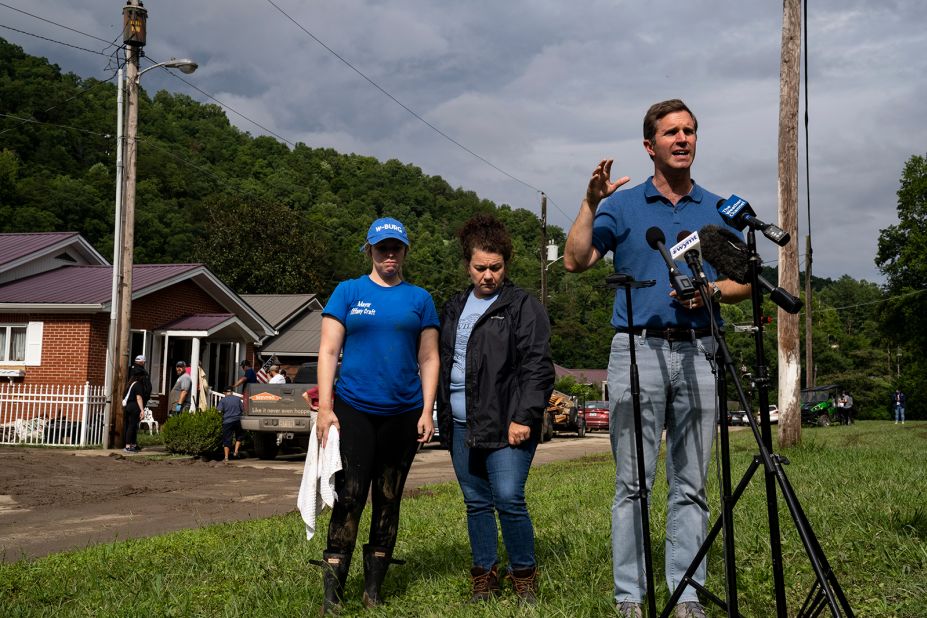 Kentucky Gov. Andy Beshear speaks to the media Sunday in Whitesburg, Kentucky.  Behind him are Whitesburg Mayor Tiffany Craft, left, and state Rep. Angie Hatton.