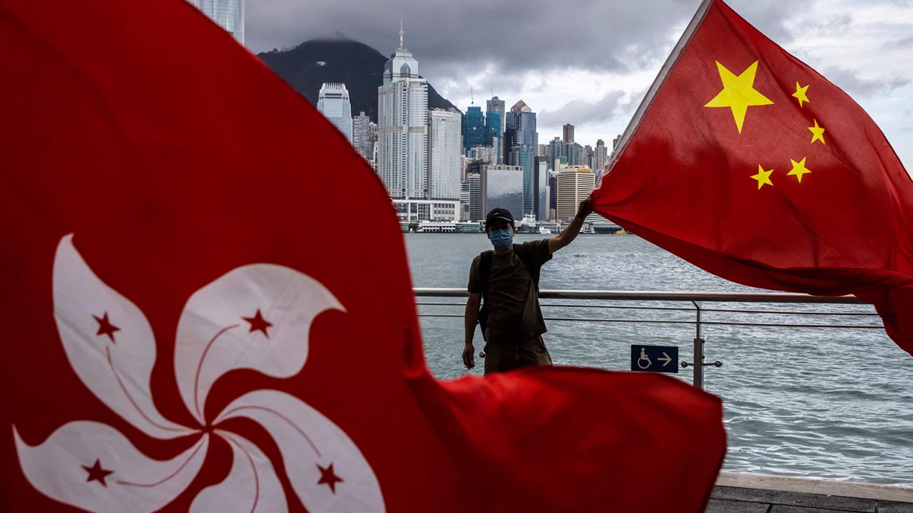 A man waves the Chinese flag to celebrate the 25th anniversary of Hong Kong's handover from Britain to China on July 1, 2022. 