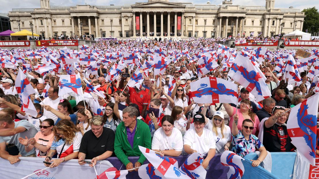 England supporters wave flags as they wait for the arrival of the England team.