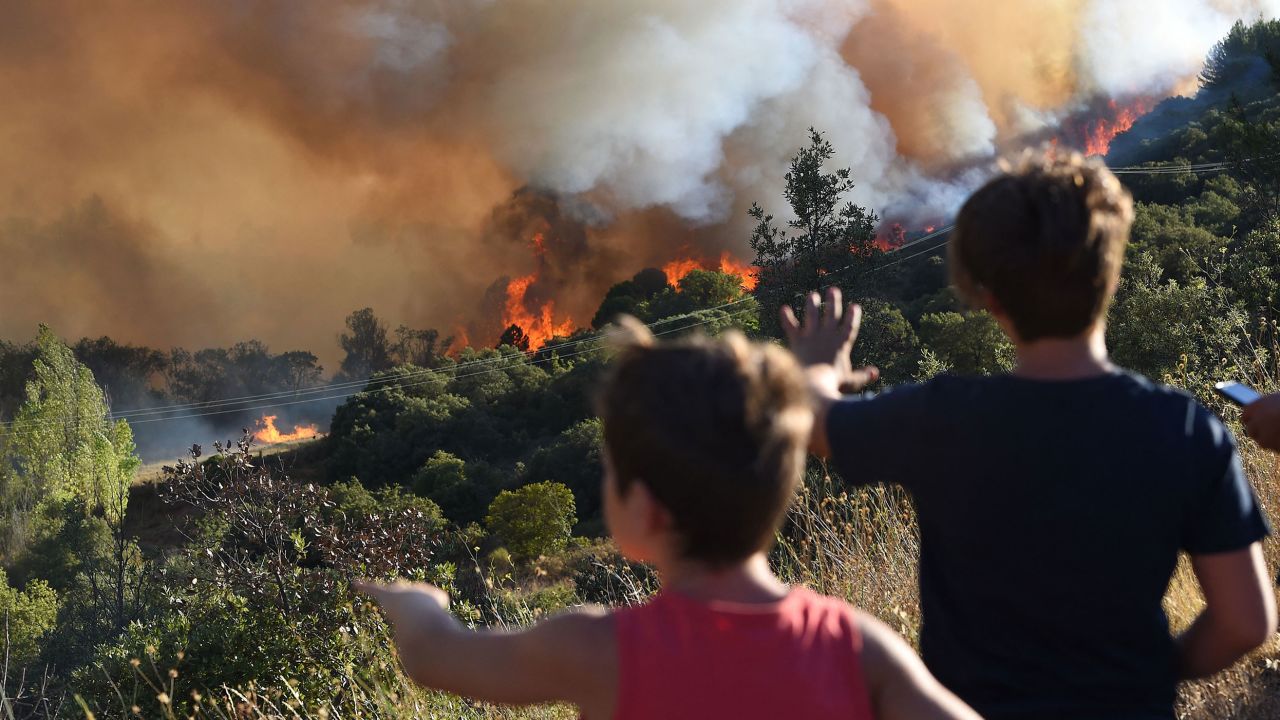 People looking at a forest fire near Gignac in southern France on July 26. 
