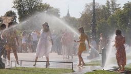 Tourists refresh themselves with water at the Jardin des Tuileries during a warm afternoon in Paris, France. On July 19, 2020.  (Photo by Mehdi Taamallah/NurPhoto via Getty Images)