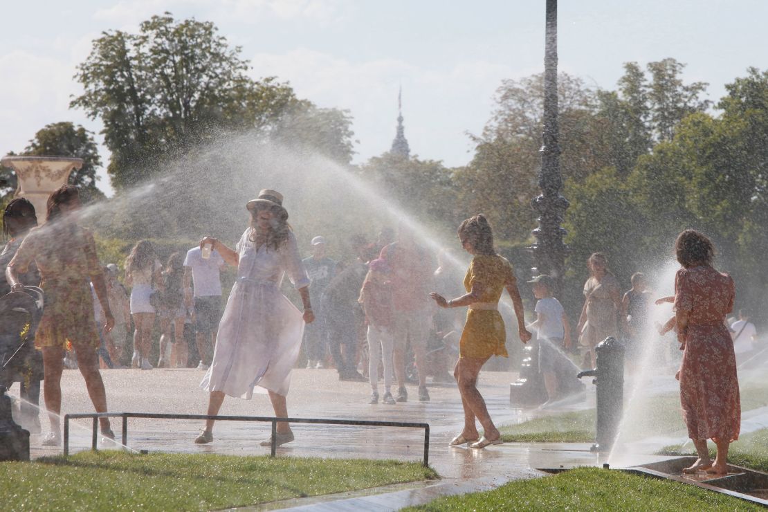 People cool down at the Jardin des Tuileries on a hot afternoon in Paris.