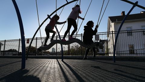 Households with vulnerable family members may decide to focus on outdoor activities for kids as a precaution. Kids play at the Betty Price Playground in Worcester, Massachusetts, on October 19, 2021.