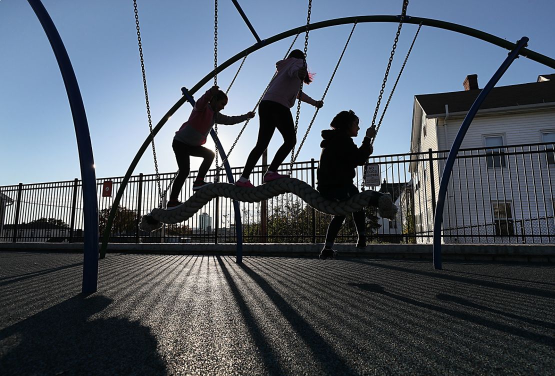 Households with vulnerable family members may decide to focus on outdoor activities for kids as a precaution. Kids play at the Betty Price Playground in Worcester, Massachusetts, on October 19, 2021.