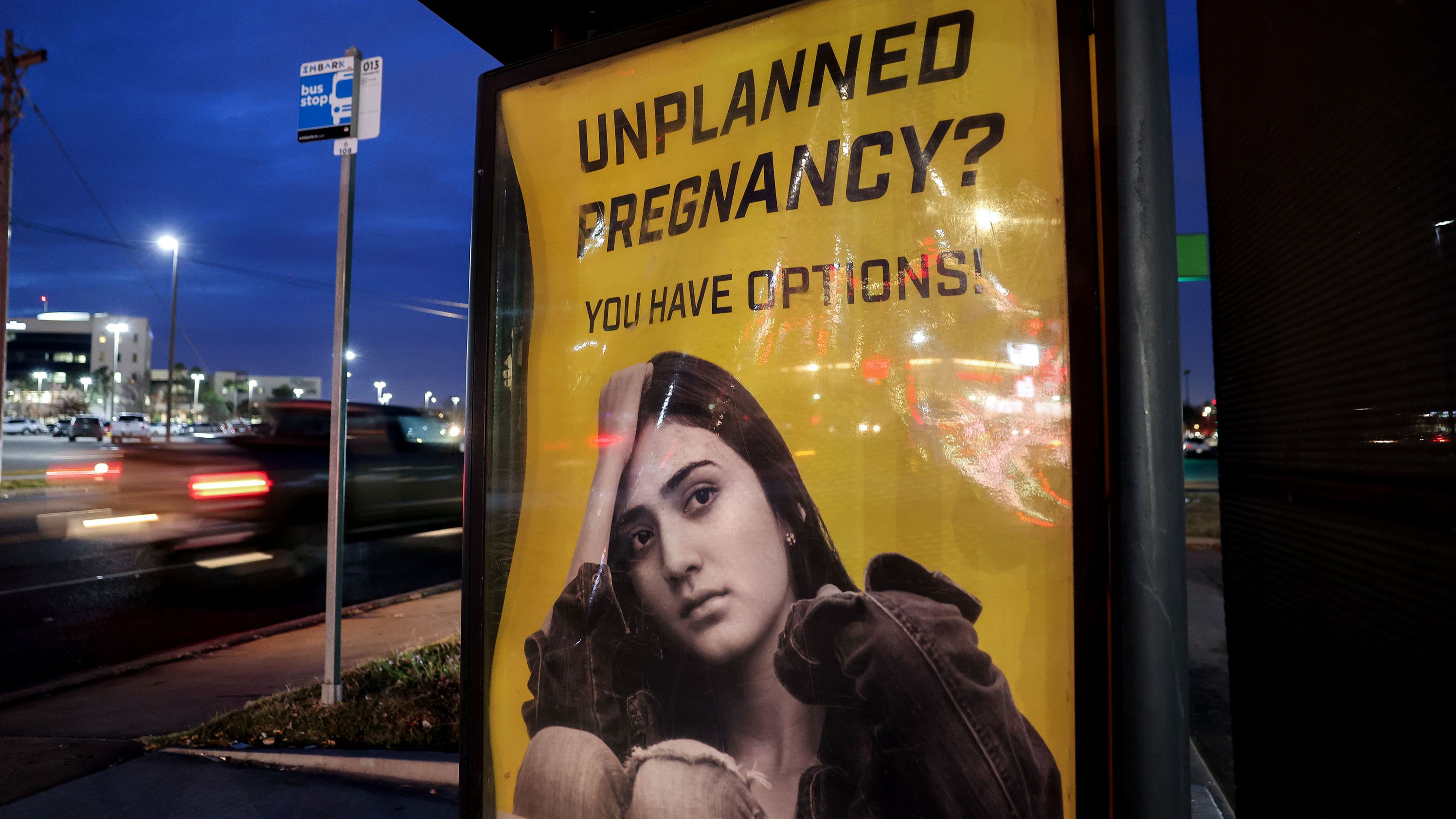 A billboard advertising adoption services targets pregnant women at a bus stop in Oklahoma City, Oklahoma, December 7, 2021. 