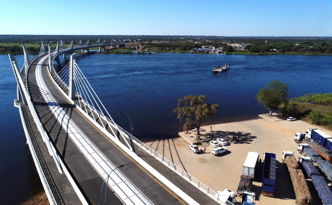 The Kazungula bridge over the Zambezi river connects Botswana and Zambia. Over 900 meters long, its curved shape steers clear of waters belonging to neighboring Namibia and Zimbabwe. The bridge, which replaces a ferry, was built to speed up truck traffic along a key north-south artery and opened in May 2021. It also has a train line running through its center, which will carry freight and passenger carriages in the future, say its managers.