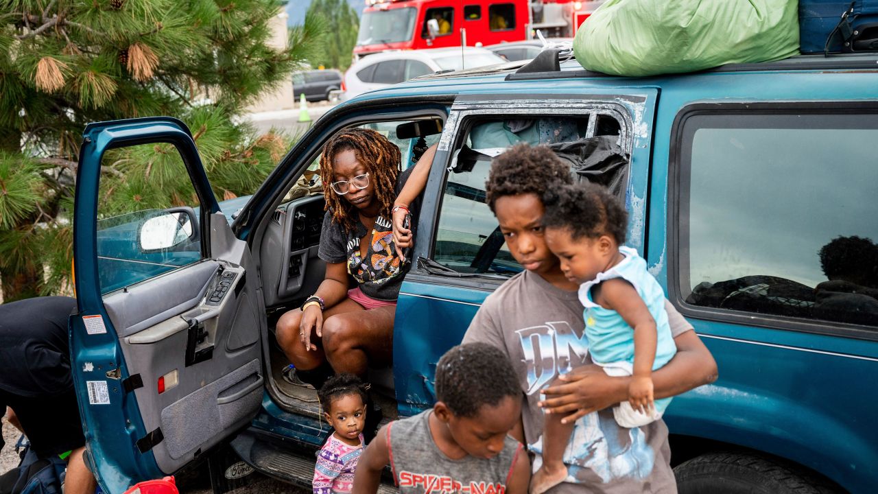 Paisley Bamberg and her family spend time outside a shelter for McKinney Fire evacuees in Weed, California, Monday.