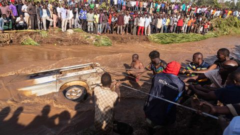 Villagers try to pull up the minibus in which 14 bodies were retrieved from inside in the river Nabuyonga in Namakwekwe, eastern Uganda, on August 1, 2022.