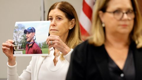 Linda Beigel Schulman holds a photo of her son, Scott Beigel, before giving her victim impact statement. 
