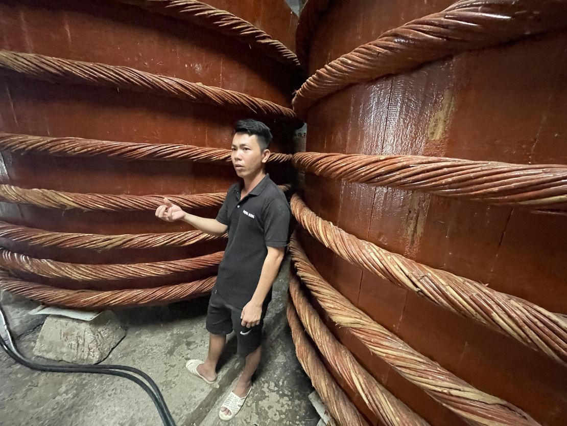 A Phung Hung employee guides visitors through the factory.