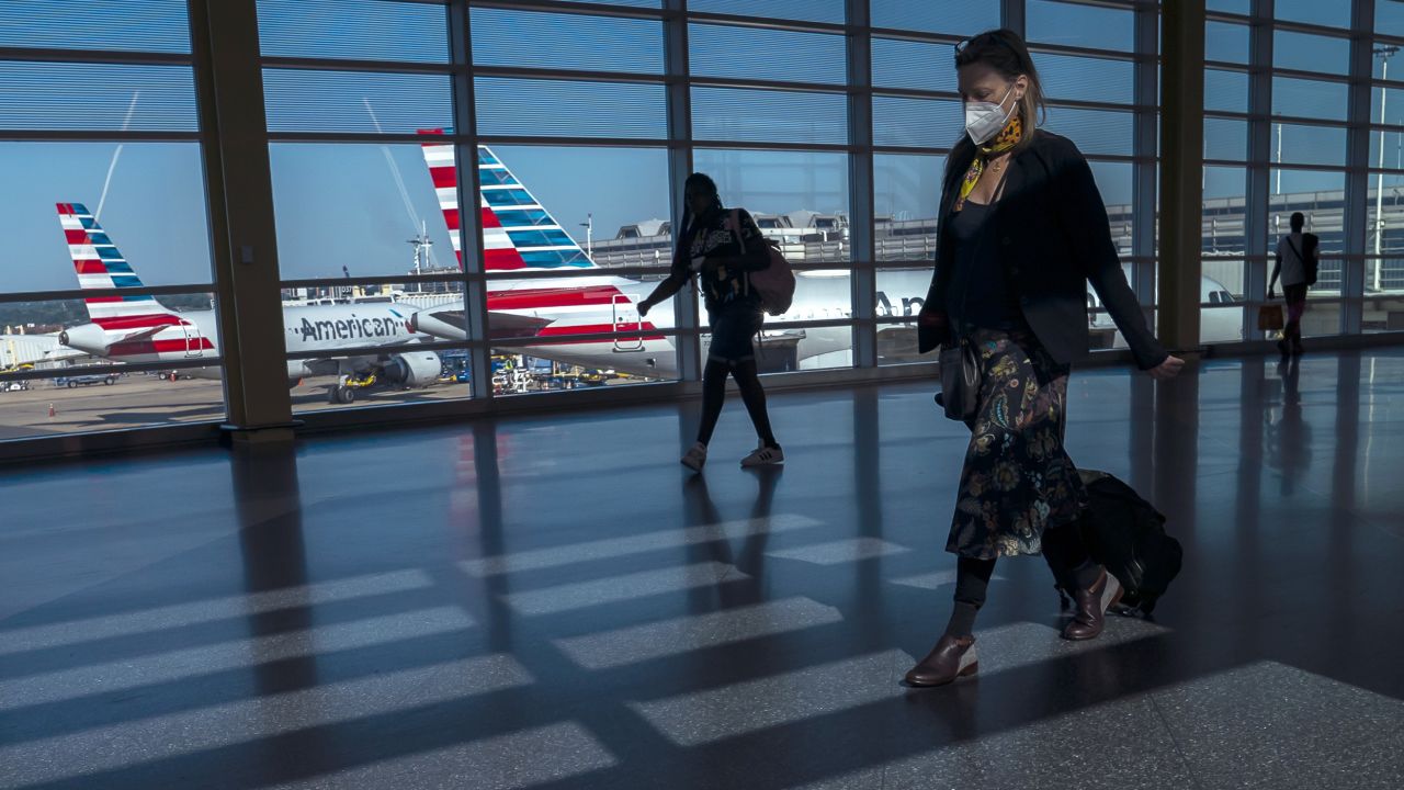 Flight cancellations have become commonplace in the US this summer. Pictured here: travelers walk past American Airlines airplanes at Ronald Reagan Washington National Airport in July.