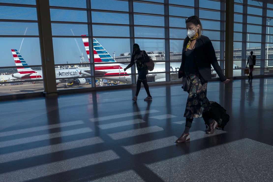 Flight cancellations have become commonplace in the US this summer. Pictured here: travelers walk past American Airlines airplanes at Ronald Reagan Washington National Airport in July.