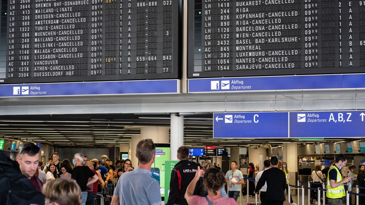 Flight attendants say the unpredictable schedules caused by cancellations and delays is tough. Pictured here: flight information boards displaying canceled flights at Germany's Frankfurt Airport in July.