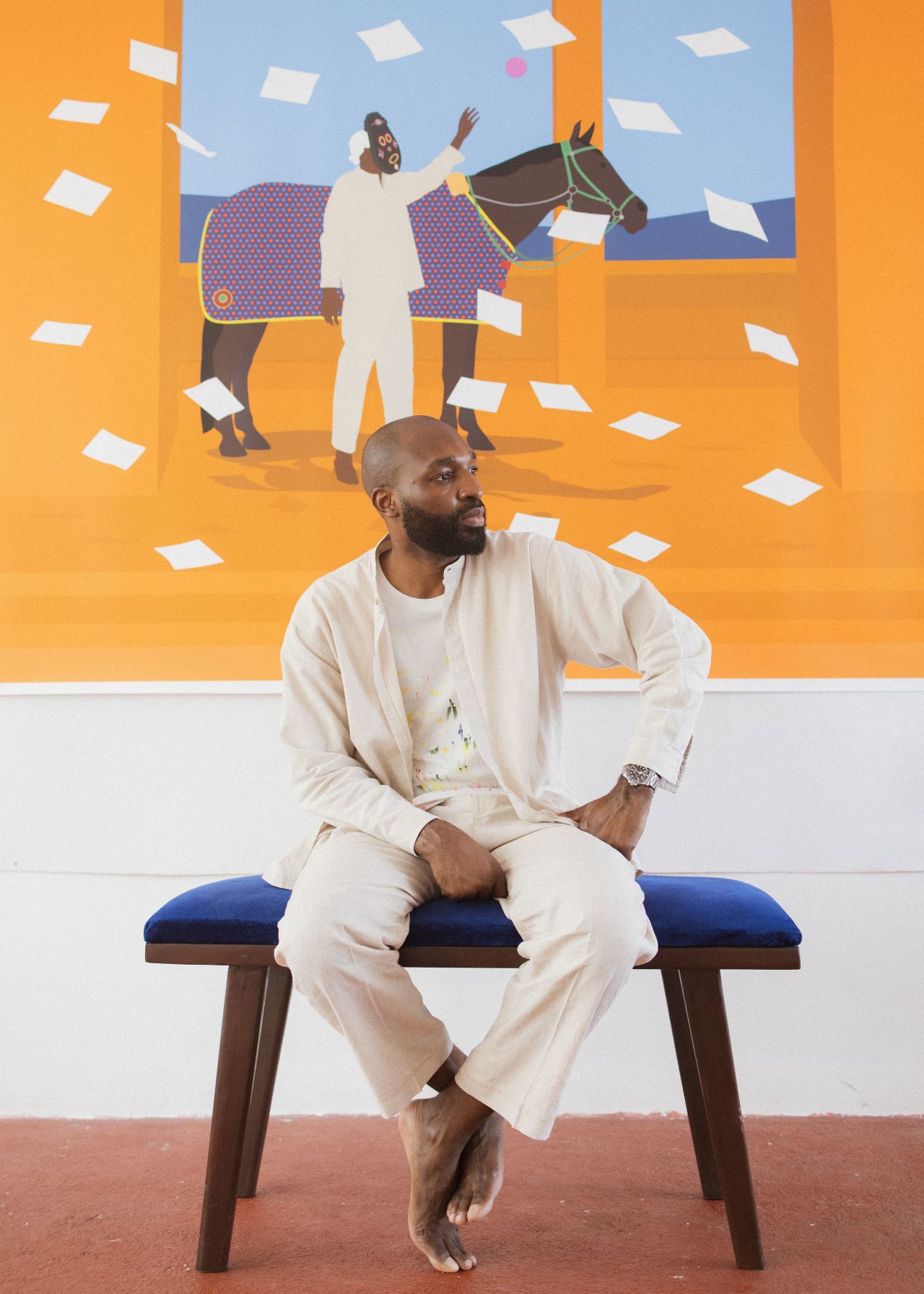 Osadebe poses in front of "Knowledge Seeker" (2022), part of his series of self-portraits.