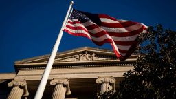 FILE PHOTO: An American flag waves outside the U.S. Department of Justice Building in Washington, U.S., December 15, 2020. REUTERS/Al Drago/File Photo