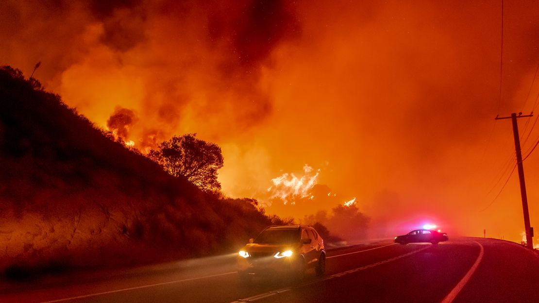 SILVERADO CANYON, CA - DECEMBER 03: Cars head north to escape the Bond Fire as it crosses Santiago Canyon Road near Silverado Canyon on Thursday, December 3, 2020.