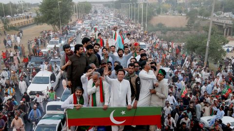 Pakistan's former Prime Minister Imran Khan gestures as he travels on a vehicle to lead a protest march in Islamabad on May 26, 2022. He was ousted on April 10 following a vote of no confidence over allegations of economic mismanagement.
