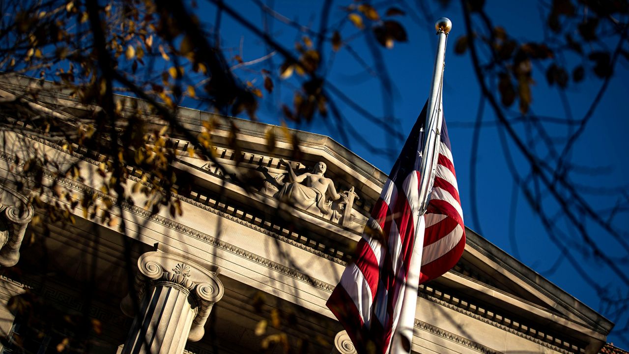 An American flag waves outside the Department of Justice Building in Washington on December 15, 2020. 