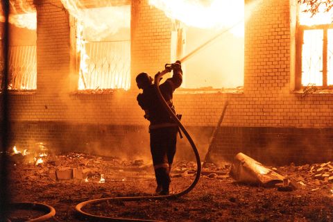 A firefighter extinguishes a burning hospital building hit by a Russian missile strike in Mykolaiv, Ukraine, on August 1.