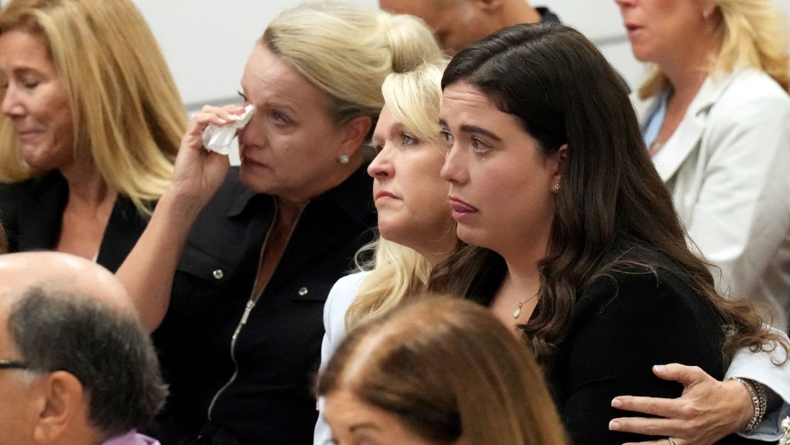 Gena Hoyer holds her daughter, Abby, as Tom Hoyer testifies about their son Luke, who was killed in the Parkland shooting.