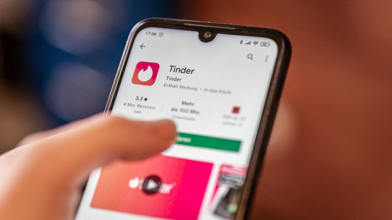 The Tinder app is shown on a mobile phone. 