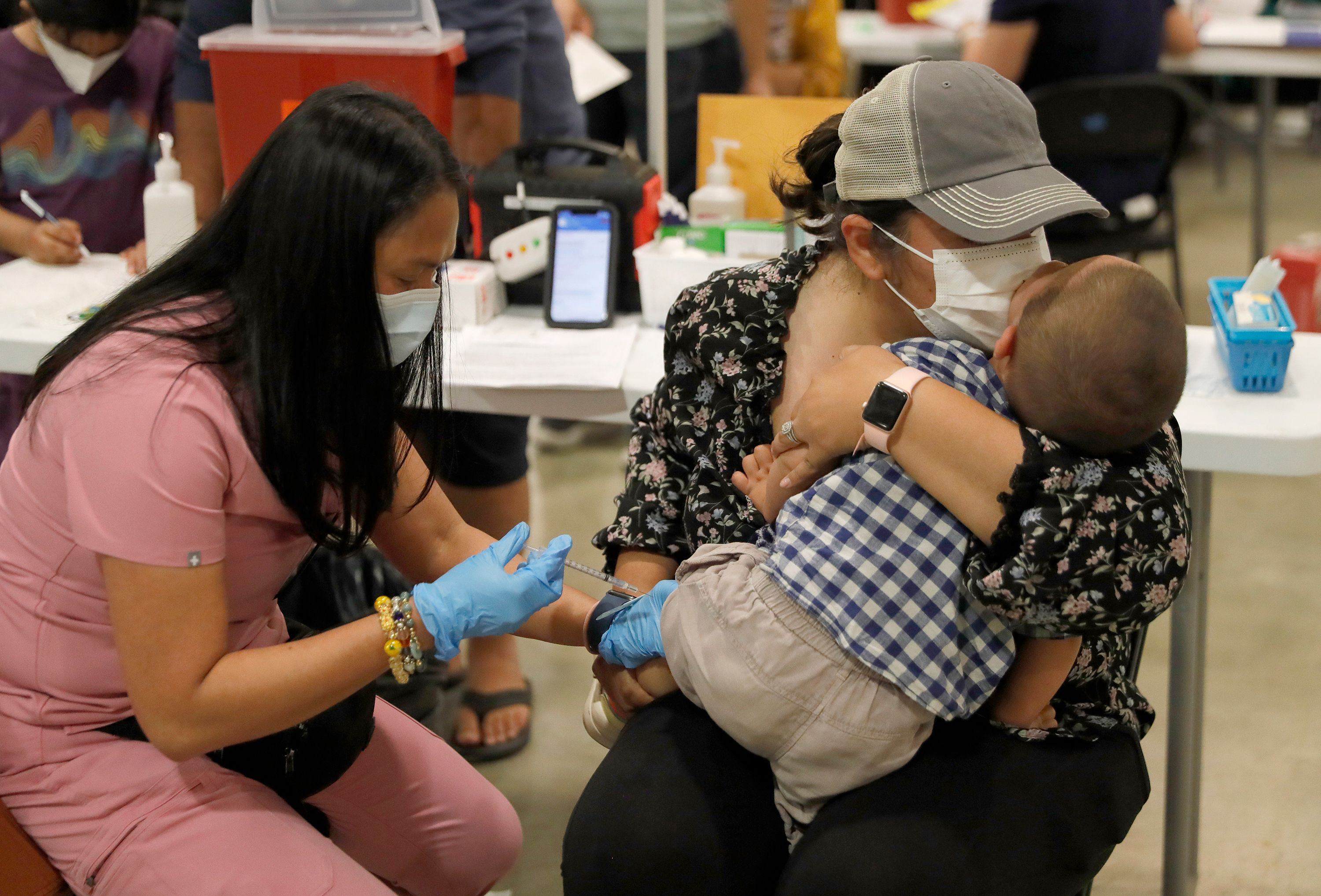 School students and their parents wait to receive their COVID-19 vaccines  as Morocco launches a campaign to vaccinate 12-17 year olds before the  start of the school year, in Rabat, Morocco, Tuesday