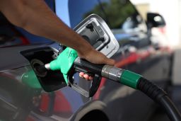 A driver pumps fuel at an Esso Tesco petrol station on July 24, 2022 in London, England. Many Supermarket Fuel Stations are still charging high prices on the forecourt despite wholesale prices coming down over the last few weeks. 