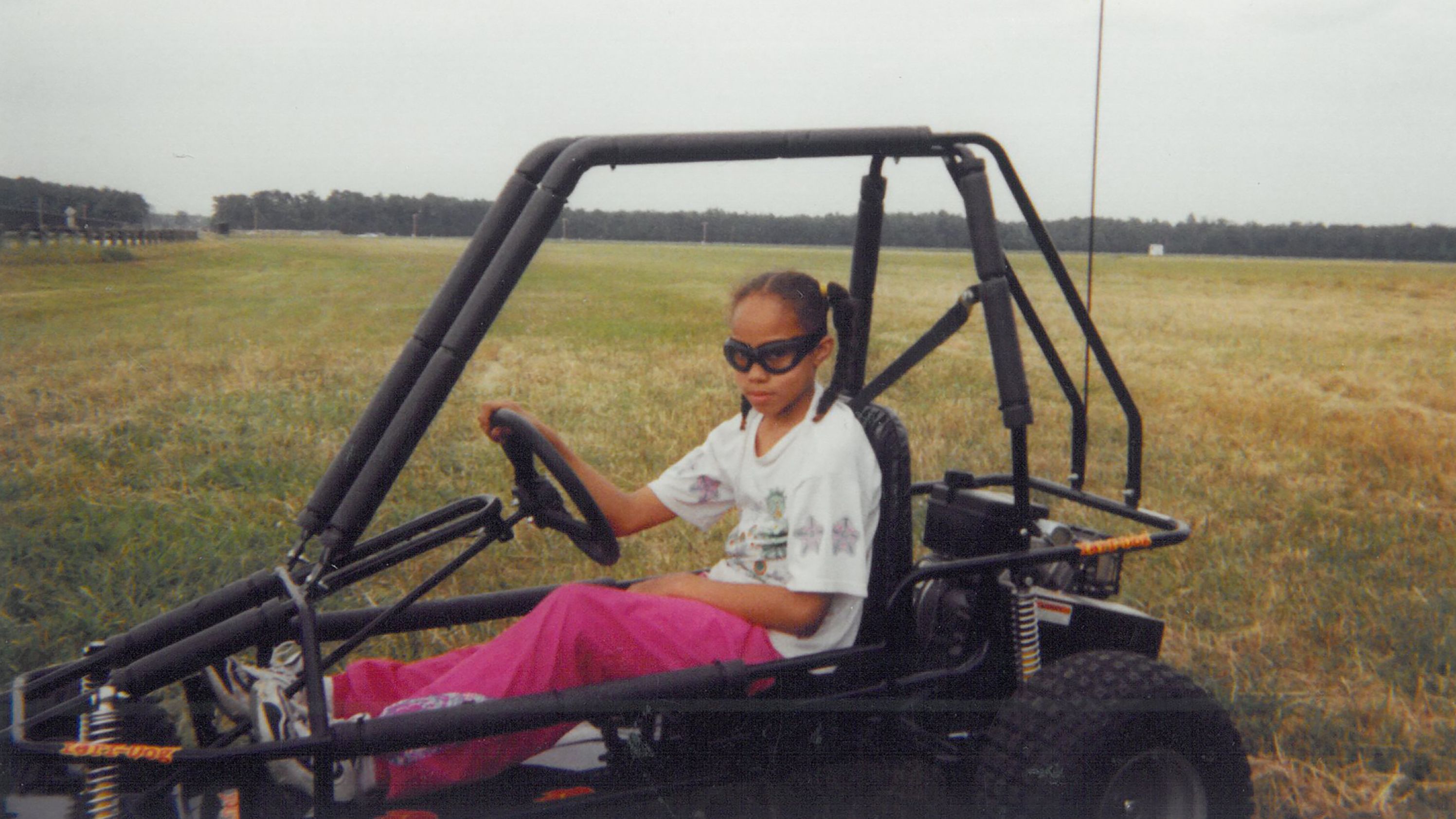 A young Griner, then in seventh grade, drives a four-wheeler.