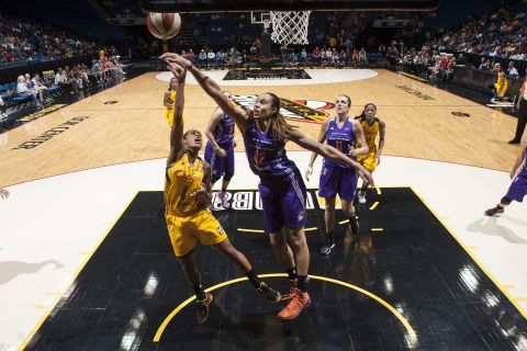 Griner blocks a shot by Skylar Diggins #4 of the Tulsa Shock during the WNBA game at the BOK Center in Tulsa, Oklahoma, in June 2014.