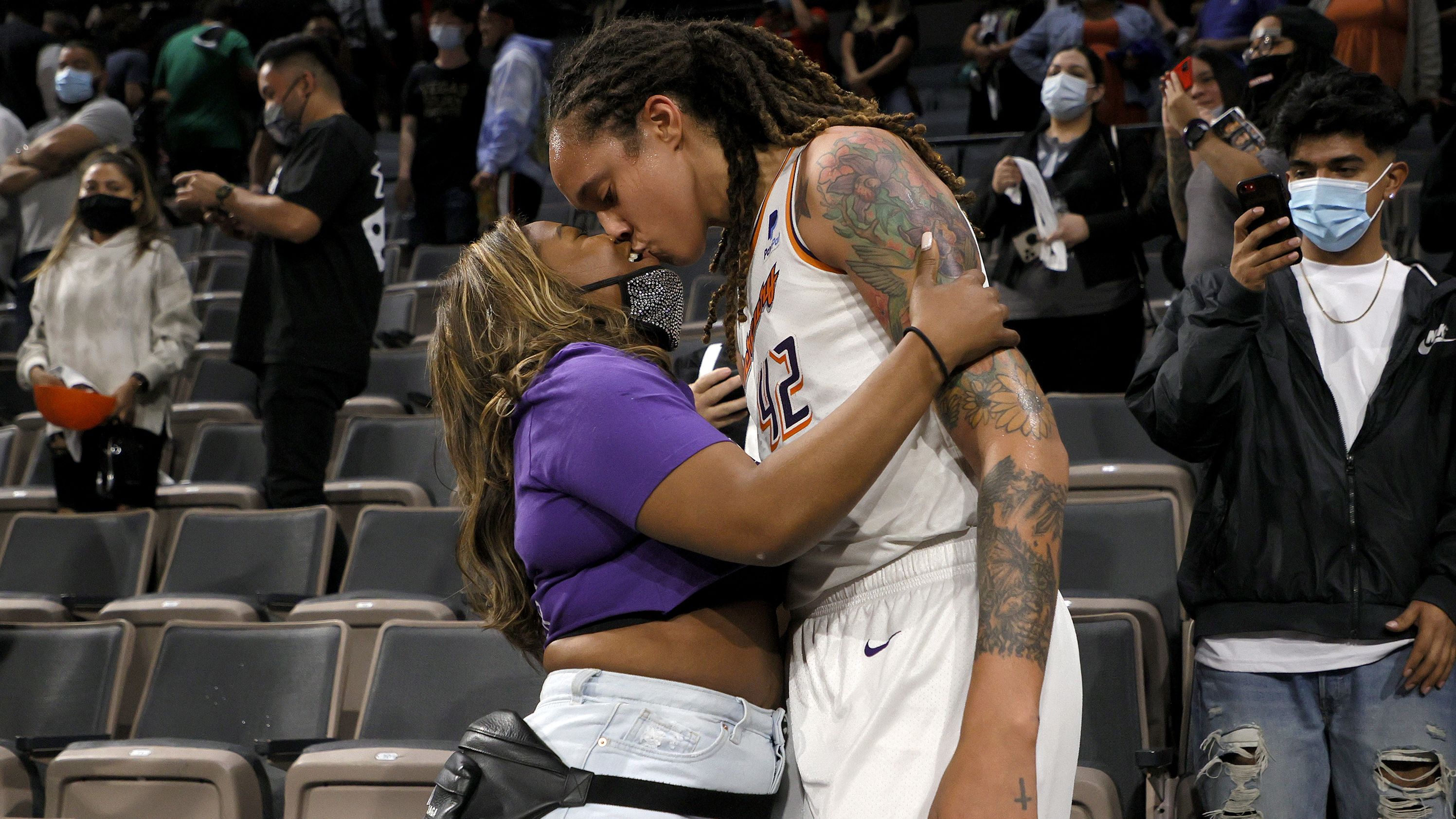 Griner kisses her wife, Cherelle, after a playoff win in 2021.