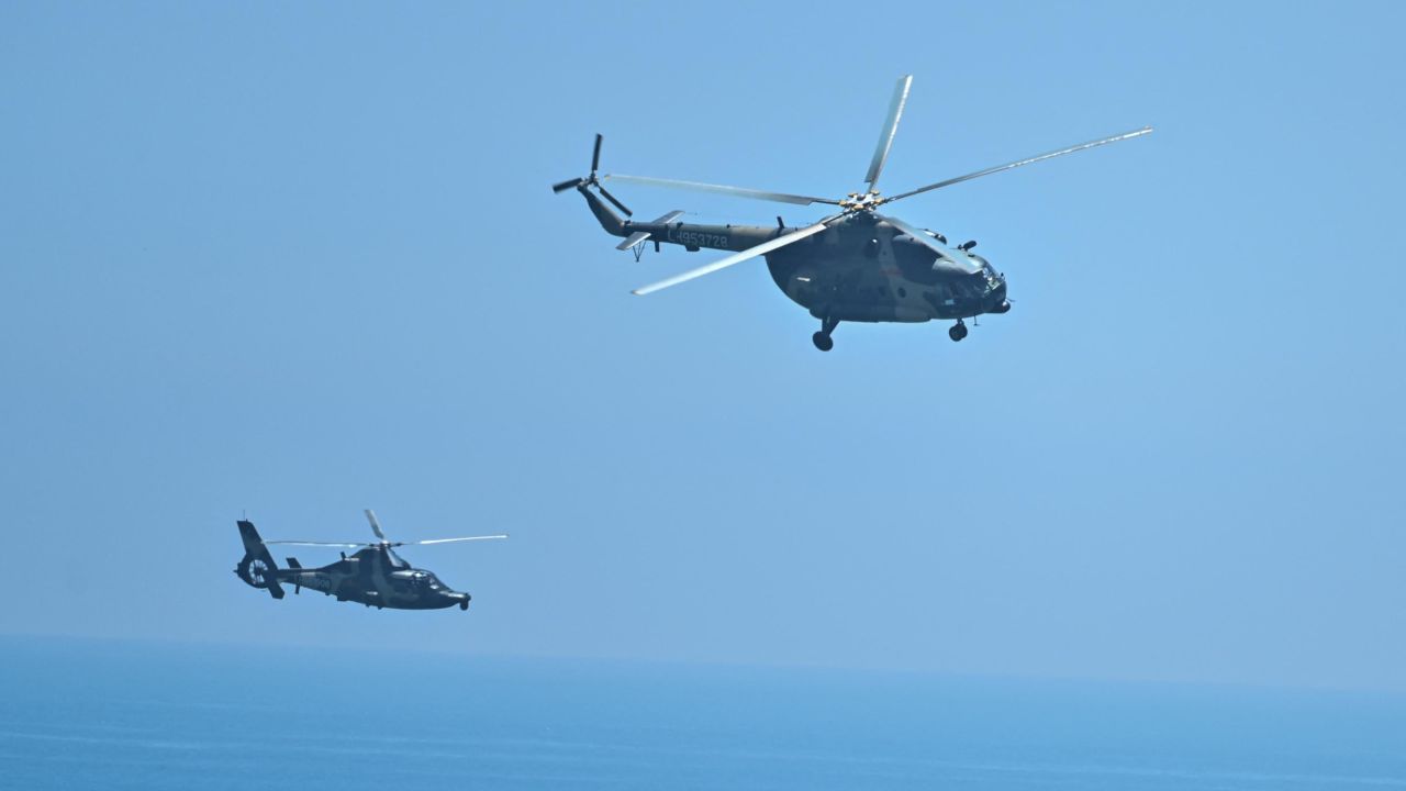 Chinese military helicopters fly past Pingtan island, which lies between the Chinese mainland and Taiwan, on August 4 ahead of military drills in the Taiwan Strait.