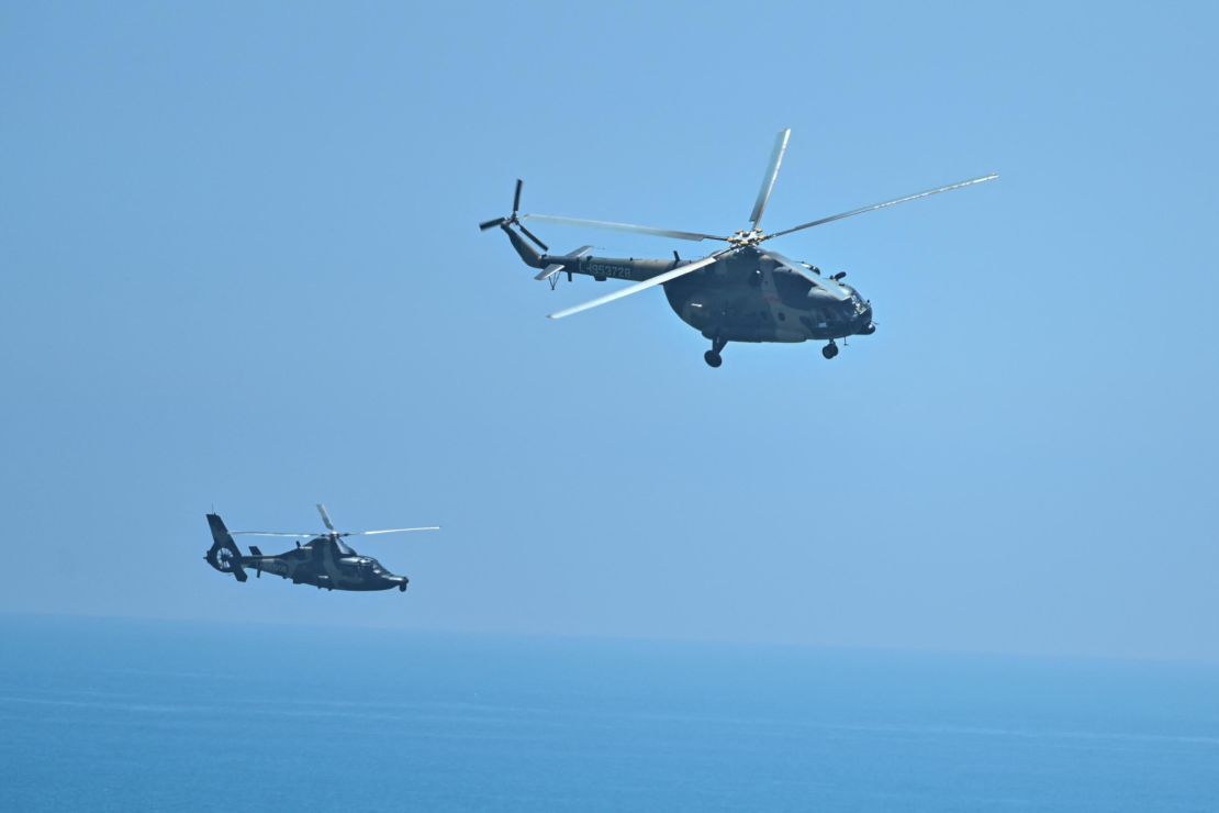 Chinese military helicopters fly past Pingtan island in Fujian province on Aug. 4.