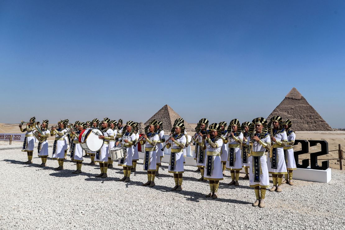 Marching band members dressed in ancient Egyptian clothing perform ahead of the Pyramids Airshow 2022 at the Giza Pyramids necropolis, on the southwestern outskirts of the Egyptian capital, Cairo, on August 3.  