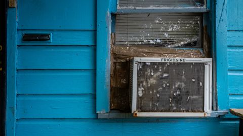 An air conditioning unit is seen in a window seal during a heatwave on July 21, 2022 in Houston, Texas. Excessive heat warnings have been issued across Texas with a predicted high of 102 degrees in Houston.