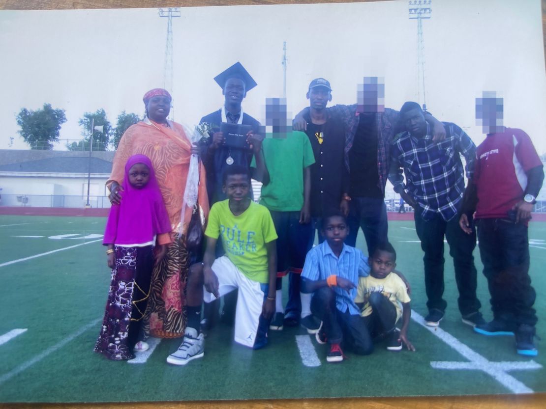 A Jeylani family photo: Top row: Mom, Madina, older brother, Abdikadir, dad, Abdi, older brother, Faisal. Bottom row: younger sister, Famay, older brother, Ali, older brother Abdullahi and Issa. CNN has blurred the faces of other family and friends present for privacy.